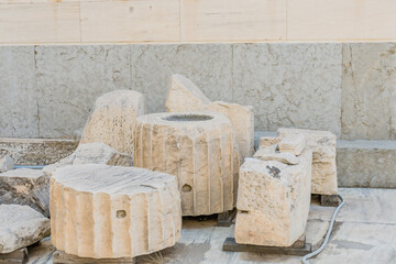 Several carved marble fragments from an ancient archaeological site, in Athens Greece