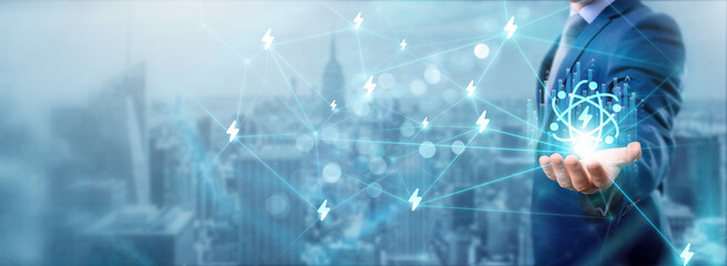 Businessman holding energy technology icon, networking and innovating solutions, sustainable connections, advancing clean energy, enhancing efficiency, renewable services, and strategic partnerships.