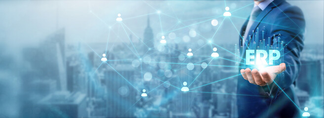 Businessman holding ERP icon, networking and managing resources, streamlining operations, enhancing...