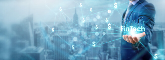 Businessman holding fintech icon, networking and facilitating transactions, digital connections, financial services, innovating solutions, disrupting traditional finance, and expanding their network.