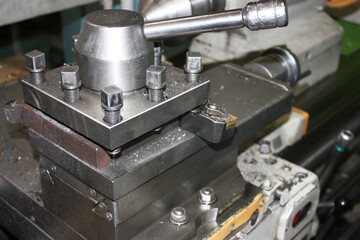Side view of the tool holder of the lathe. Professional lathe machine in a workshop. The metal...