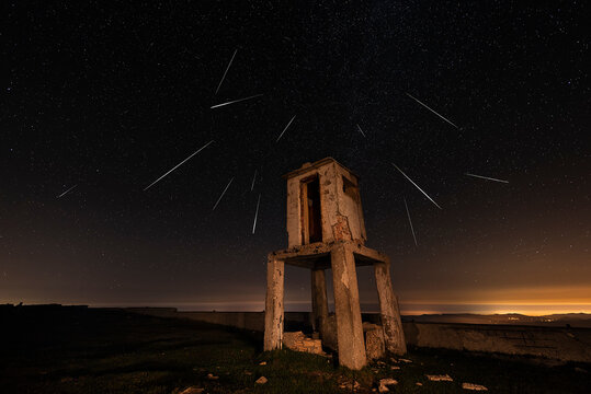 Perseid star shower over the ruins of a watchtower at the top of Picon Blanco, Espinosa de los Monteros, Burgos