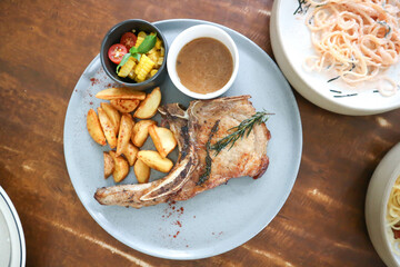  pork chop or grilled pork with French fries and salad