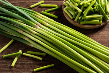 fresh garlic bolt on wooden table.