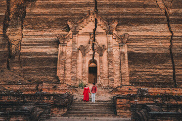 A couple walks to see the ancient pagoda Mingun Pagoda in Myanmar.