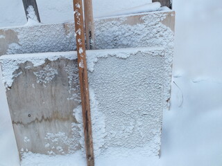 Snow covered fence winter ice snow texture cold water abstract white wall old car blue nature.  Snow covered fence pattern black frost frozen concrete glass grunge.
