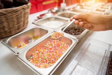 Young woman in the workshop during a lesson on making handmade chocolates and sweets