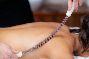 Metal rolling pin provides therapeutic back scraping massage, enhancing well-being and serenity.. - 790577380