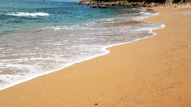 Sea surf on the beach of St. Cristina in Lloret de Mar, Catalonia
