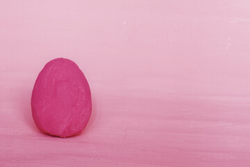 Dark pink decorative egg on a red background.