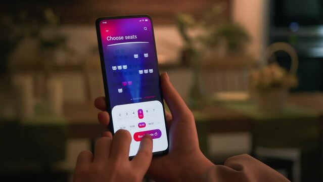 Buying cinema tickets online. Choosing seats in movie theater and buying tickets using app for mobile phone.