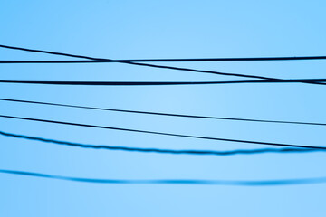 Power lines hanging between poles.