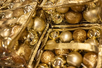 Golden christmas ornaments in plastic packaging.