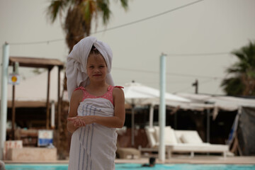 Girl in a towel after swimming in the pool
