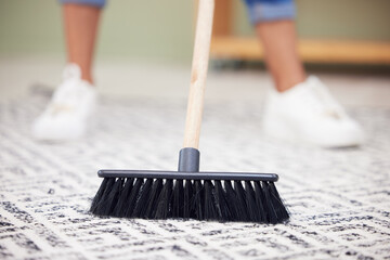 Legs, broom and carpet in home, living room and spring cleaning service for dust, bacteria or dirt...