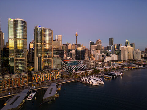 Sydney, Australia - July 19 2023: Aerial view ferry waits at the Barangaroo Wharf in the Darling Harbor newly redeveloped district in downtown Sydney at sunset.