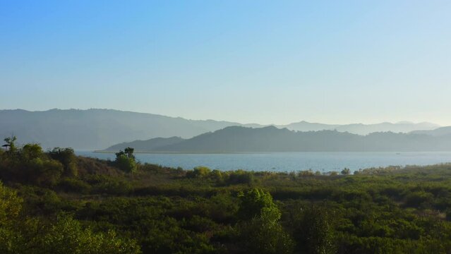 4K drone footage of Lake Casitas, California. A drinking water reservoir in Ventura County. The recreation area is surrounded by wild nature and inhabited by wild animals. Sunny weather before sunset