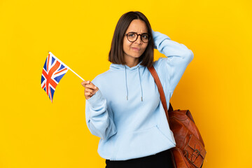 Young latin woman holding an United Kingdom flag isolated on yellow background having doubts