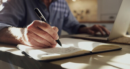 Hand, notebook and writing with person in home for finance management, planning or wealth closeup....