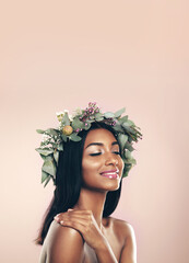 Crown, flower and natural with beauty of Indian woman in studio isolated on pink background for cosmetics. Aesthetic, eyes closed and goddess of happy young model at salon or spa makeup for wreath