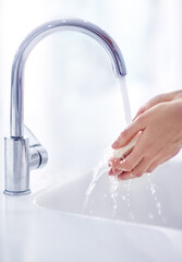Soap, tap and washing hands in bathroom for hygiene, skincare and germ protection or wellness at...