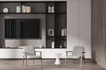 Stylish chill room interior with tv console and armchairs on hardwood floor