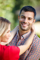 Obraz premium Couple, portrait and outdoor hug in nature, together and love in relationship or bonding in embrace. Happy people, support and marriage on holiday or vacation, relax and commitment or connection