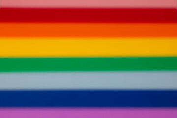 LGBTQ+ gay pride flag is reimagined as a dreamy haze in this image, with the rainbow edges softened...