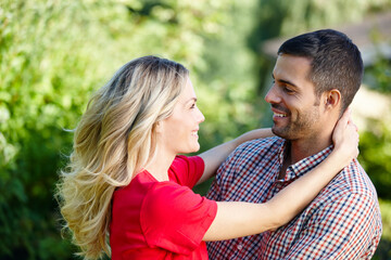 Fototapeta premium Couple, embrace and outdoor marriage by trees, together and love in relationship or bonding in nature. Happy people, support and hugging on holiday or vacation, relax and commitment to connection