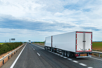 Truck with two refrigerated semi-trailers joining a highway, new sizes of vehicles called...