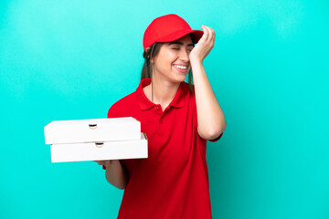 Pizza delivery woman with work uniform picking up pizza boxes isolated on blue background has...