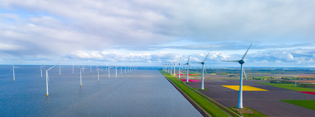 A serene scene unfolds as wind mills stand tall around a vast lake, harnessing the power of the wind in the Netherlands during Spring