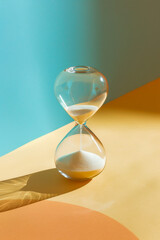 Isolated hourglass on a color background, minimalism design