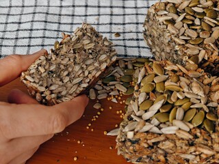 healthy bread, close-up, Lena pumpkin seeds and seeds in the palms, buckwheat bread, freshly baked,...