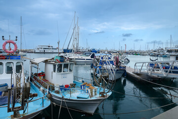 LIMASSOL, CYPRUS - APRIL 15, 2024: Old port of Limassol with beautiful fishing boats at sunset