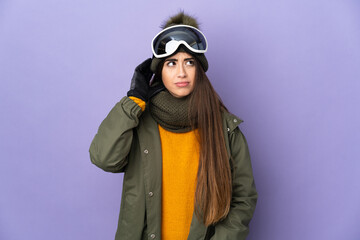 Skier caucasian girl with snowboarding glasses isolated on purple background having doubts