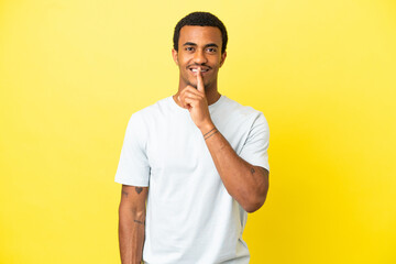 African American handsome man on isolated yellow background showing a sign of silence gesture...