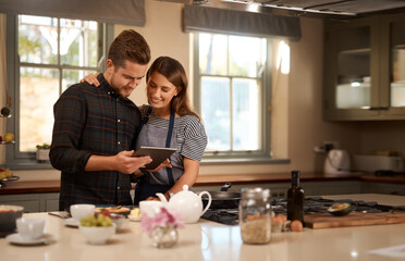 Couple, cooking and tablet for online recipe in home or ingredients on digital food app, meal or internet. Man, woman and happy in kitchen for wellness nutrition or dinner together, website or health