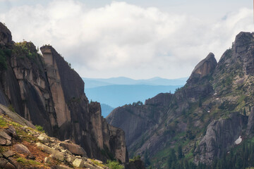 Awesome scenic view to great mountains in distance behind deep gorge.