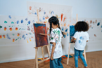 Students painting on canvas show artist skill in drawing class. Kid paint canvas all around use...