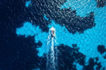 Vacation and leisure. Aerial view on fast boat on blue Mediterranean sea at sunny day. Fast ships...