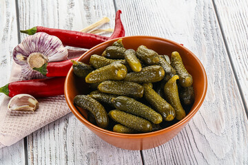 Marinated small cucumbers in the bowl