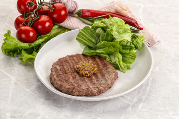 Frilled beef burger cutlet with iceberg