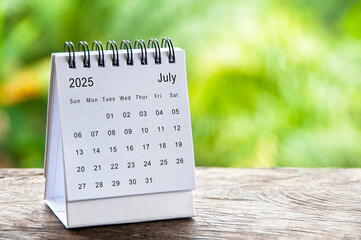 July 2025 white table calendar with customizable space for text. Calendar concept and copy space