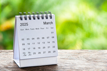 March 2025 white table calendar with customizable space for text. Calendar concept and copy space.