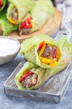 Beef and vegetable cabbage leaves wraps, served with plain yogurt, vertical