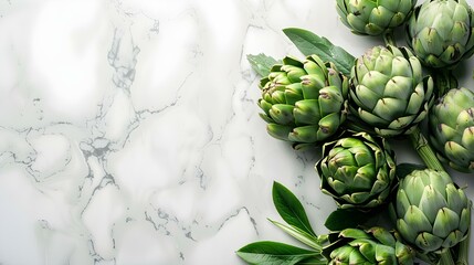 Artichokes lie on the white marble countertop