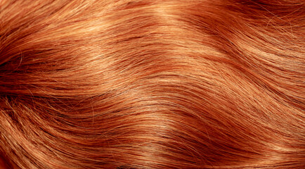 Red hair close-up as a background. Women's long orange hair. Beautifully styled wavy shiny curls....