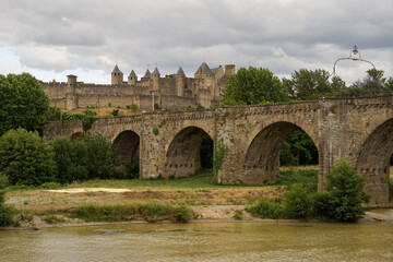 Fototapeta na wymiar Medieval bridge Pont Vieux with Carcassone castle panoramic view, popular tourist landmark in France