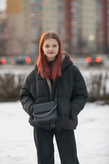 Portrait of a young beautiful red-haired girl.